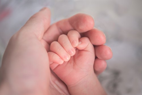 Holding newborn hand.jpg